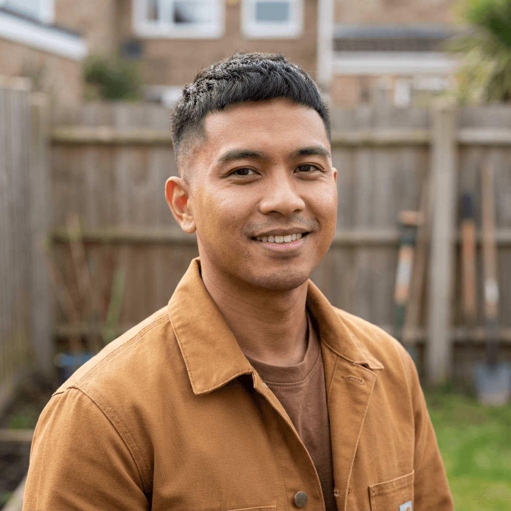 Male contractor standing in front of a house under construction